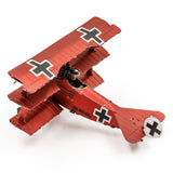 Metal model of a red Fokker Dr.I Triplane with black crosses on a white background