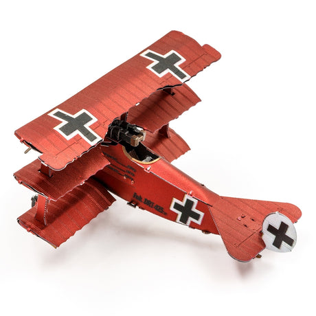 Metal model of a red Fokker Dr.I Triplane with black crosses on a white background