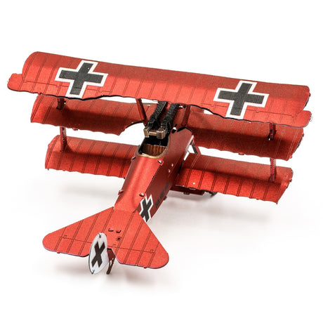 Metal model of a red Fokker Dr.I Triplane  with black crosses on wings against a white background