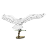 Metal model of Hedwig the owl on a white background
