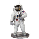 Metal models of a Apollo 11 Astronaut in a white space suit with a helmet on a white background