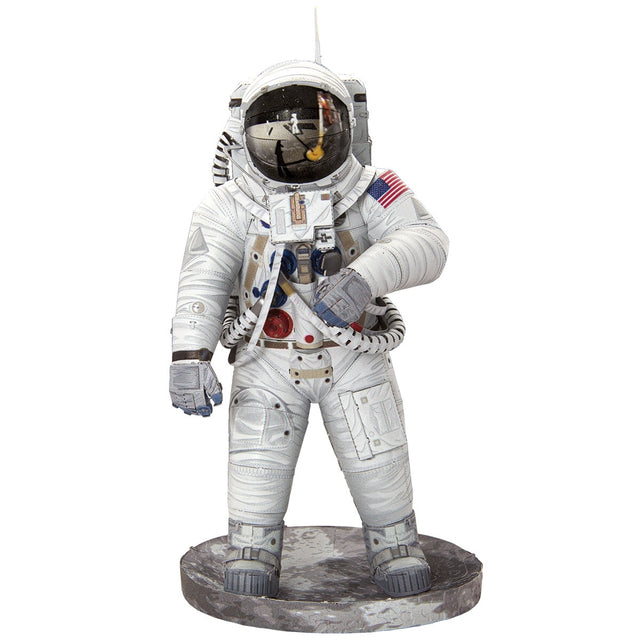 Metal models of a Apollo 11 Astronaut in a white space suit with a helmet on a white background