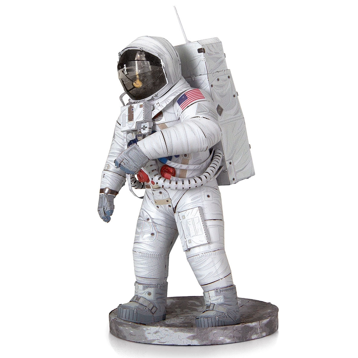 Metal models of a Apollo 11 Astronaut in a white space suit with a flag patch on a white background