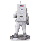 Metal models of a Apollo 11 Astronaut in a space suit with NASA logo on a white background