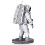 Metal models of a Apollo 11 Astronaut in a space suit with a white background