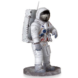 Metal models of a Apollo 11 Astronaut in a space suit on a white background