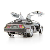 Metal model of a DeLorean car with open doors on a white background