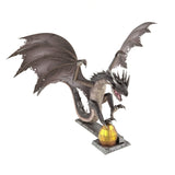 Metal model of a Hungarian Horntail from Harry Potter on a white background