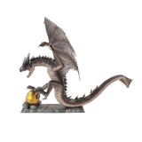 Metal model of a Hungarian Horntail from Harry Potter  with a golden egg on a white background