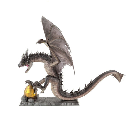 Metal model of a Hungarian Horntail from Harry Potter  with a golden egg on a white background