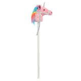 Plush unicorn on a stick with a rainbow mane against a white background