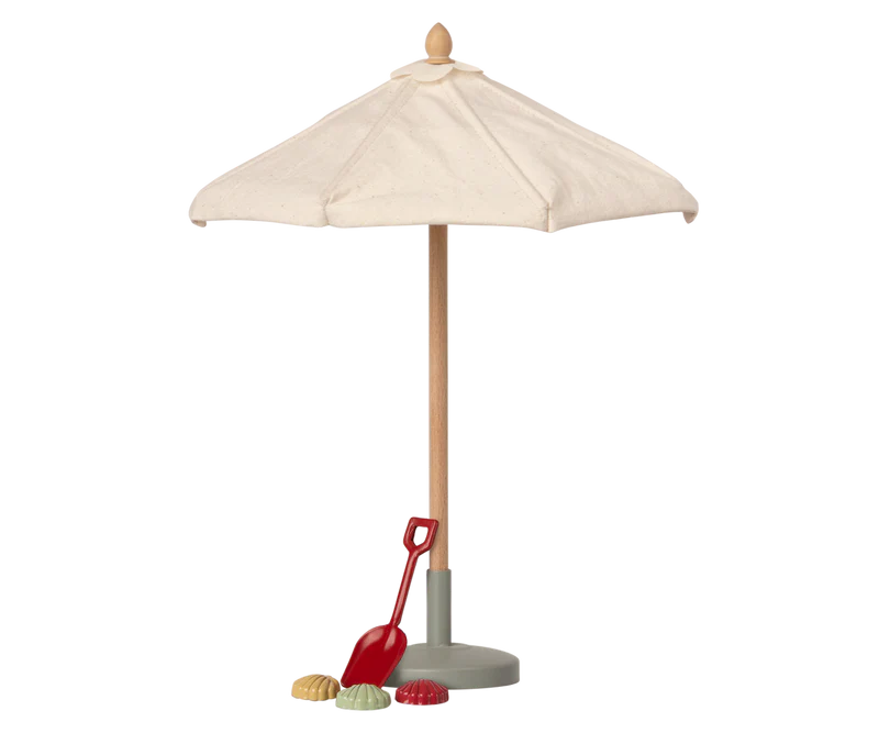 A miniature toy Maileg Sunshade, Miniature with a cream fabric canopy, a light wood pole, a gray base, and a small red shovel accessory on a plain white background.