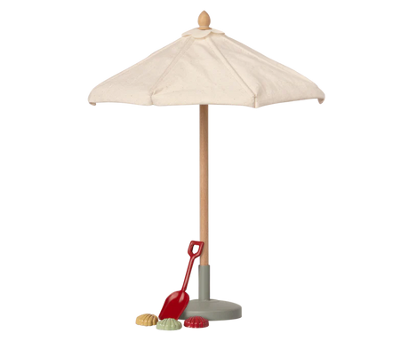 A miniature toy Maileg Sunshade, Miniature with a cream fabric canopy, a light wood pole, a gray base, and a small red shovel accessory on a plain white background.