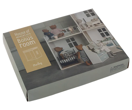 A boxed Maileg House of miniature - Bonus room set photographed on a plain white background. The package shows a printed room scene with teddy bears and furniture, plus a tan label reading 'House of miniatures Bonus Room' and the brand 'Maileg'.