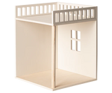 A minimalist wooden Maileg House of miniature - Bonus room with an open floor, a small window cutout on the side, and a slatted top platform, shown against a plain white background.