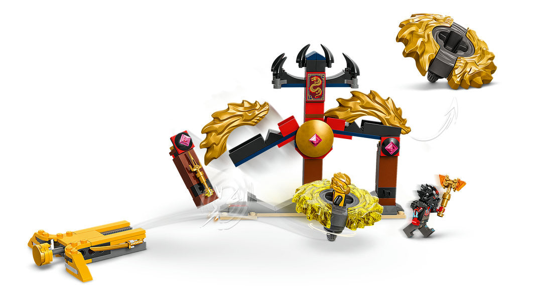 A dynamic assembly of spinning golden dragon elements and a small warrior figure launching from a cross-shaped battleground in the 71826 LEGO® Dragon Spinjitzu Battle Pack, a creative construction toy set.