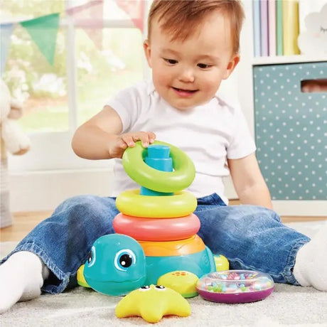 Child playing with a KidOozie - Bump Around Stacking Turtle in a bright room