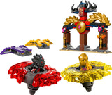 71826 LEGO® Dragon Spinjitzu Battle Pack featuring two spinning battle tops with red and yellow translucent designs, two dragon-shaped weapons, and a decorated battle stand with gold and black accents.