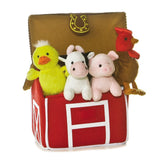 Plush farm animals in a red barn toy with a brown lid on a white background