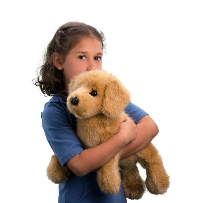 Child holding a Plush Oakley DLux Golden Retriever dog against a white background