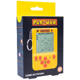 Pac-Man themed game keyring in its retail packaging. The product is a yellow handheld game keyring with red buttons and a screen, shown inside a black and yellow box featuring the 'PAC-MAN' logo and classic maze graphics.