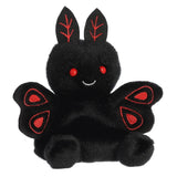 Black plush toy with red accents on a white background