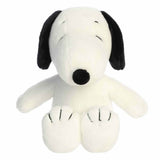 Plush toy resembling a black and white dog on a white background