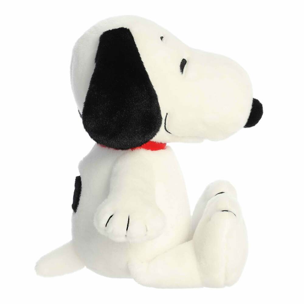 Plush toy of a black and white dog with a red collar on a white background
