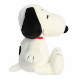 Plush toy of a black and white dog with a red collar on a white background