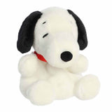 Plush toy of a black and white dog with a red collar on a white background