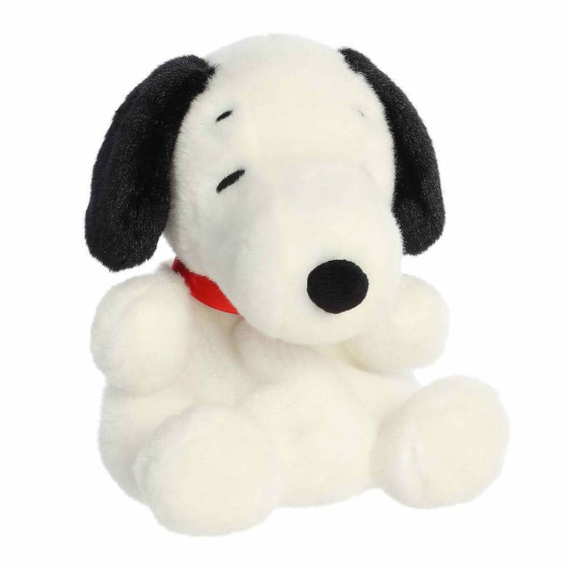 Plush toy of a black and white dog with a red collar on a white background