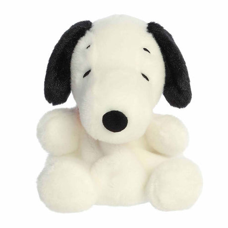 Plush toy of a black and white dog on a white background