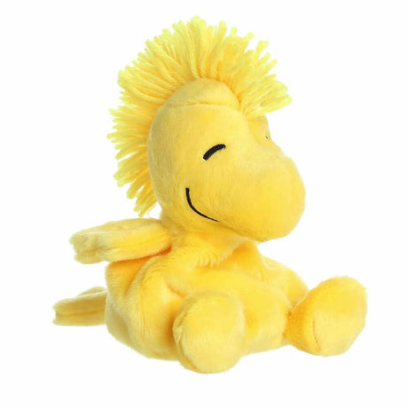 Yellow plush bird toy with a happy expression on a white background