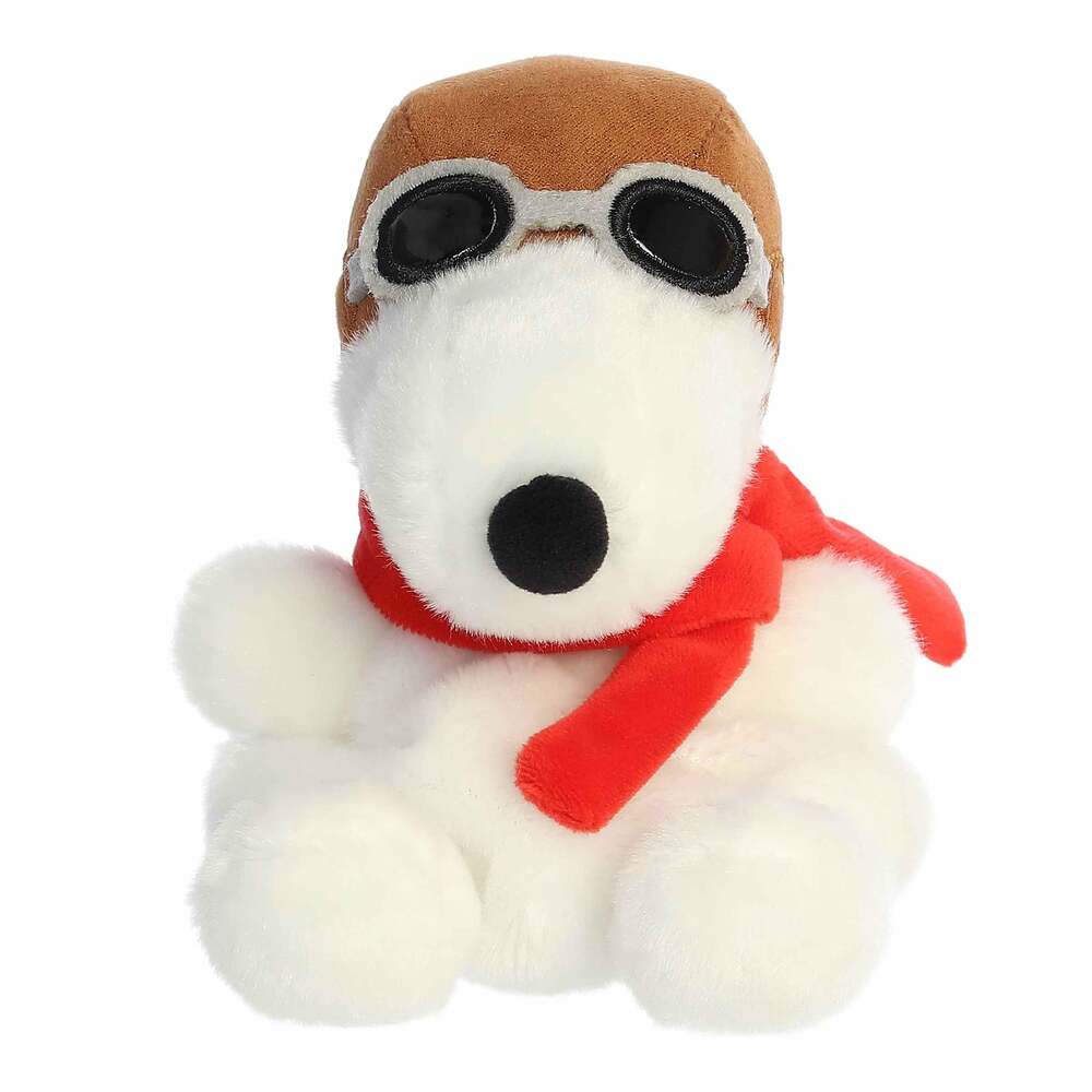 Plush toy dog with a brown hat and red scarf on a white background