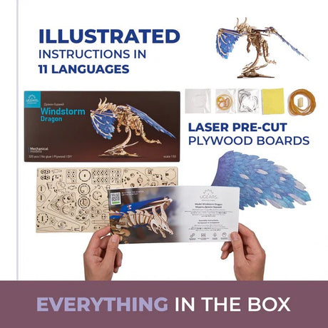 Windstorm Dragon model kit with packaging, laser-cut plywood boards, and illustrated instructions on a white background.