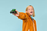 Child holding a LEGO City Brick Rides: Rides – Gaming Race Car on blue background