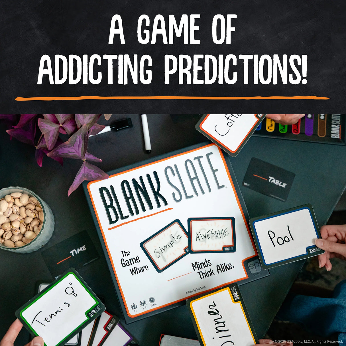 Overhead view of a tabletop game board and cards titled 'Blank Slate' with large text reading 'A Game of Addicting Predictions!' at the top. Hands are visible holding or placing cards such as 'Awesome,' 'Pool,' 'Tennis,' and 'Clinic.