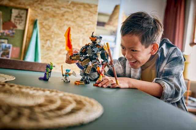 Child playing with LEGO Ninjago: Cole's Mission Mech & Dragon Zane figures at a table in a home setting