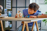 Child playing with a LEGO Star Wars: BB-8™ Astromech Droid at a table in a modern room.