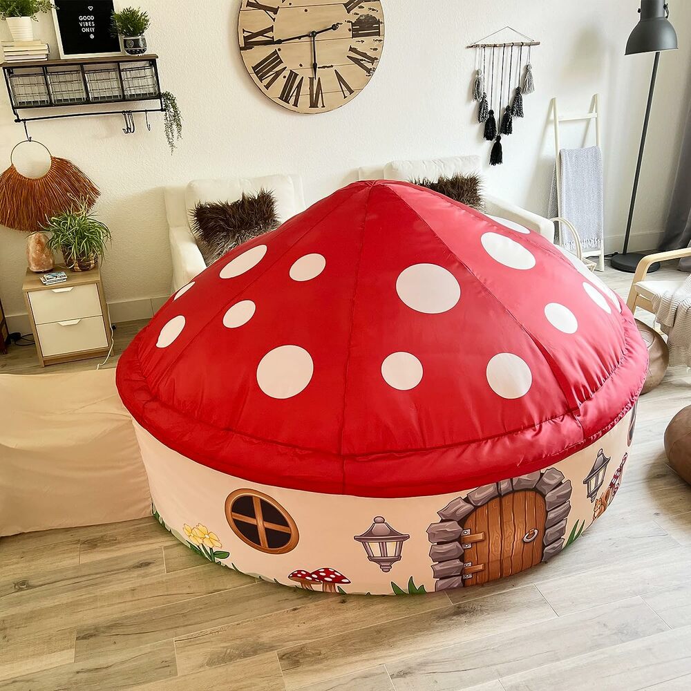 Children's Mushroom House Air Fort shaped like a mushroom in a room with wooden floor and decor.