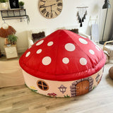 Children's Mushroom House Air Fort shaped like a mushroom in a room with wooden floor and decor.