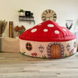 Mushroom House Air Fort designed like a mushroom with a red cap and white spots, placed in a room.