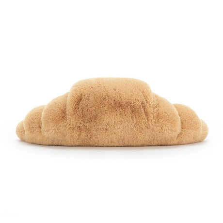 Soft and plush Amuseables Croissant toy in light brown, designed to look like a realistic croissant with a cuddly, fluffy texture perfect for kids and gift giving.