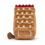 Soft plush toy shaped like a gingerbread house with white icing details and a red scalloped roof, designed as the Amuseables Gingerbread House for imaginative play.