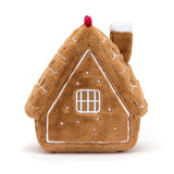 Soft plush toy designed as a cozy gingerbread house with white icing details and a red chimney top, named Amuseables Gingerbread House.