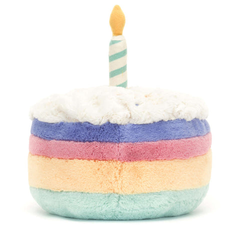 Soft plush toy designed as a colorful layered cake with white top and striped candle, perfect as a playful and cuddly Amuseables Rainbow Birthday Cake for kids.