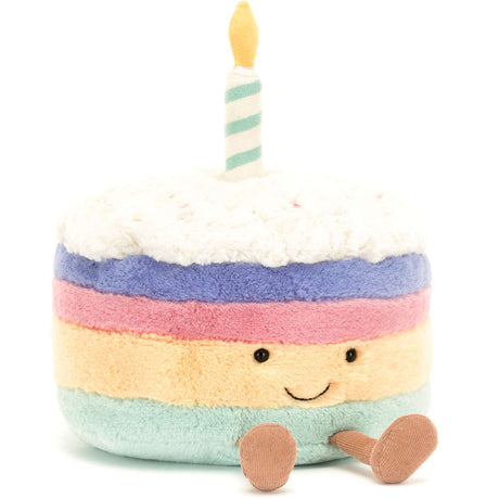 Soft plush Amuseables Rainbow Birthday Cake with colorful layers, a smiling face, and a striped candle on top, perfect as a kid's birthday gift or toy store plush.