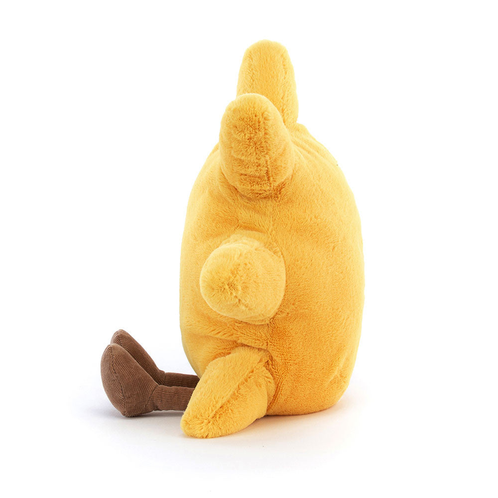 Side view of a yellow plush toy Amuseables Sun with brown feet on a white background