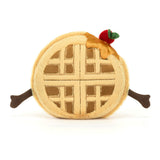 Soft plush toy designed as a waffle with a golden lattice pattern, topped with syrup and a red cherry, featuring outstretched brown arms, called Amuseables Rene Waffle.