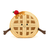 Soft plush toy shaped like a smiling waffle with arms, topped with syrup and a red cherry, designed as the Amuseables Rene Waffle for kids and toddler play.